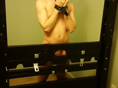 Boy Balls Leashed to Bondage Wall