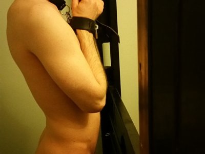 Boy Balls Leashed to Bondage Wall